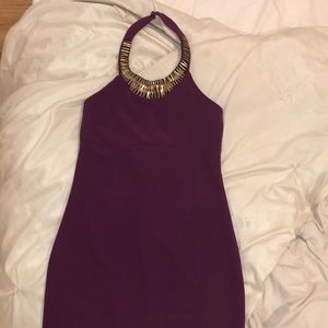 Purple dress, with a gold around the collar.